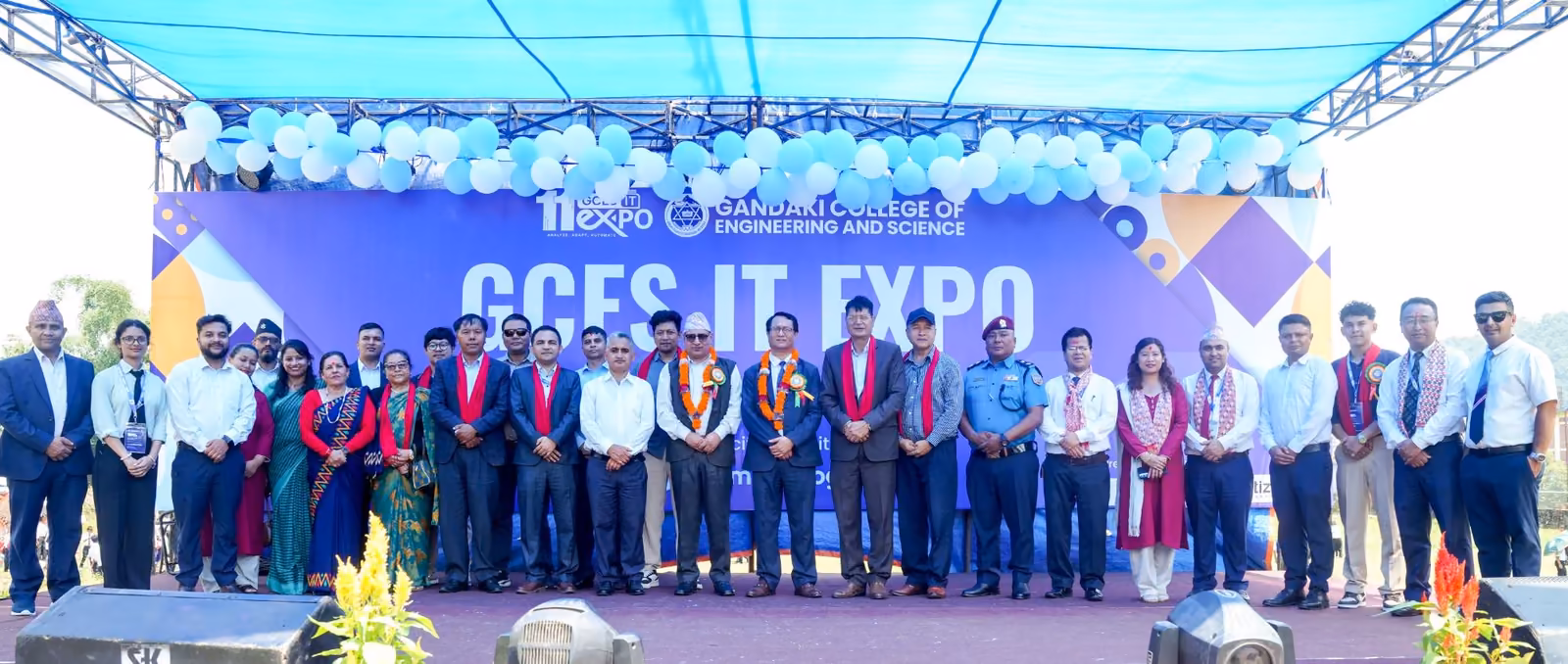 The IT expo group on a decorated stage under the college's own banner