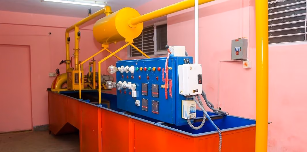 A yellow and blue rig on a steel frame with its control box, published as the hydropower set-up
