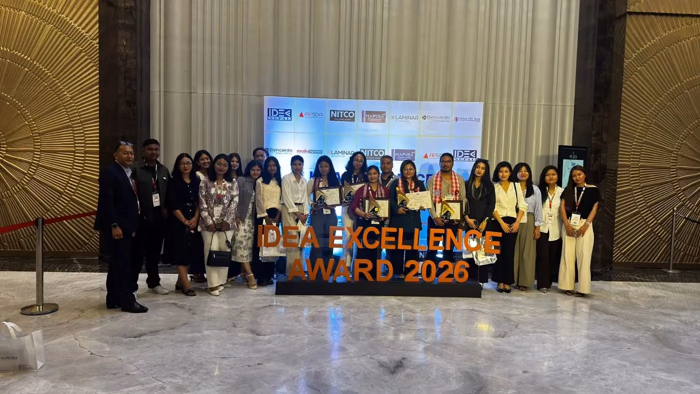 The college's group at an awards ceremony, the 2026 excellence award banner behind them