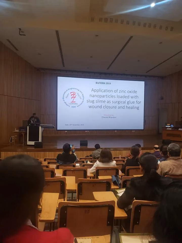 A lecture theatre in use, a research slide projected on the screen