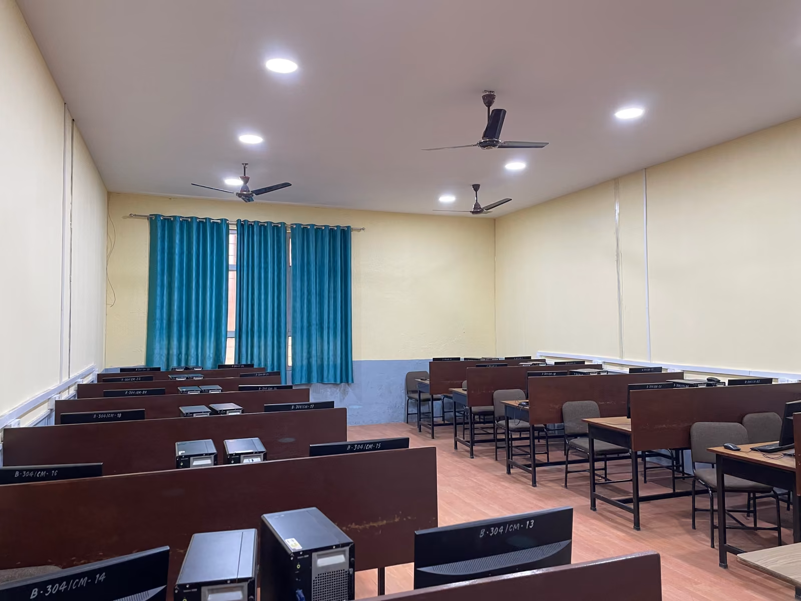 Rows of desks with tower computers in an empty teaching room